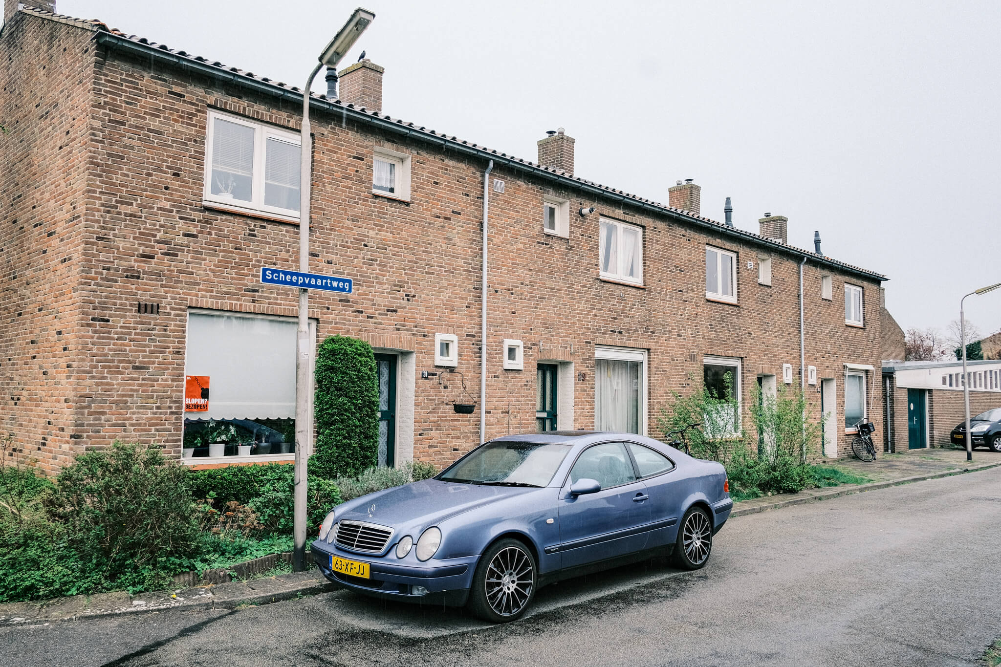 a car parked in the street of the old neighborhood