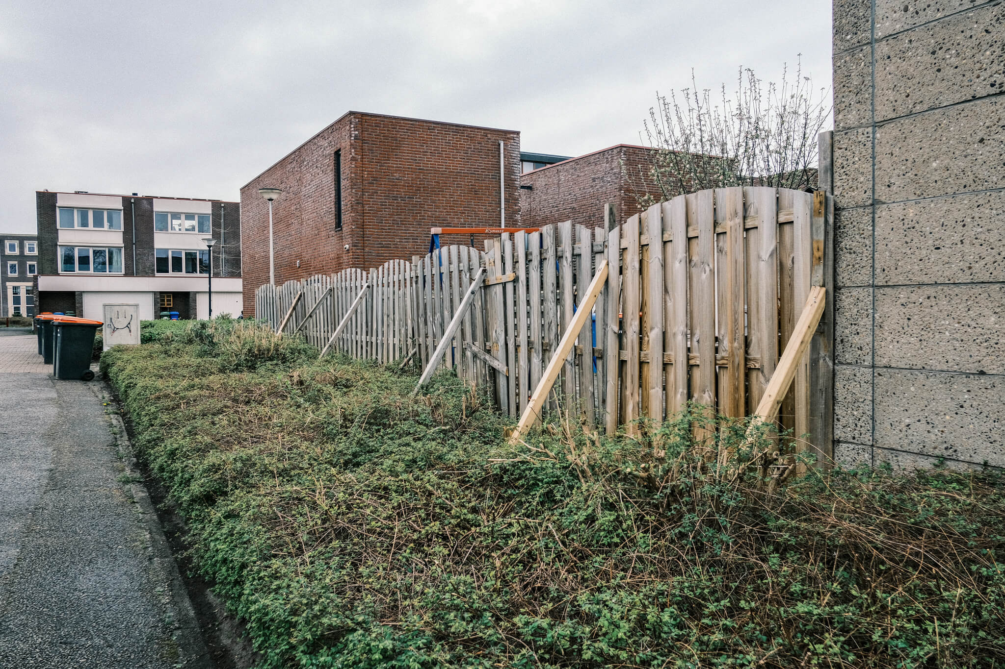 A fence being held up with multiple supports