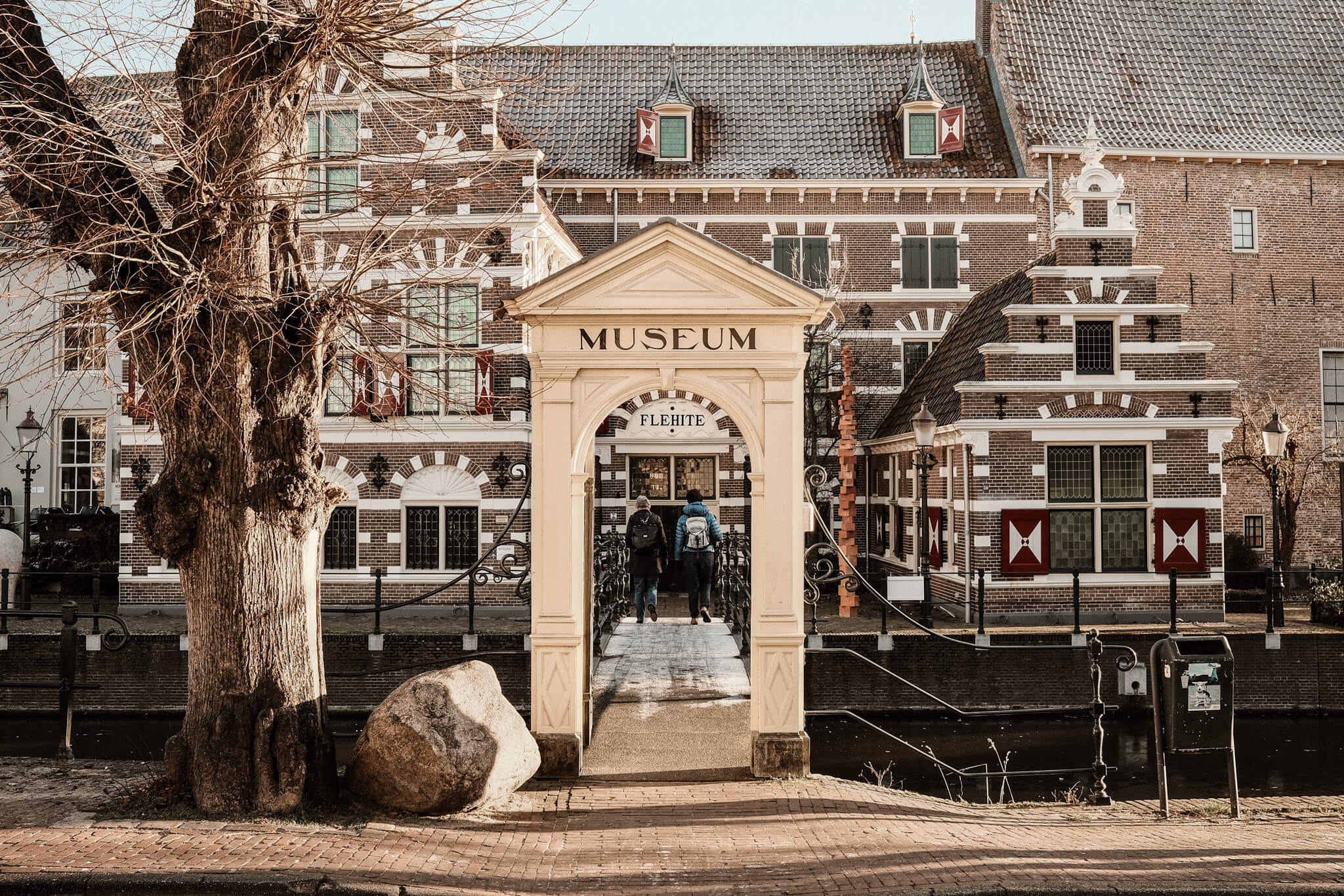 Two ladies crossing the bridge of museum Flehite in Amersfoort