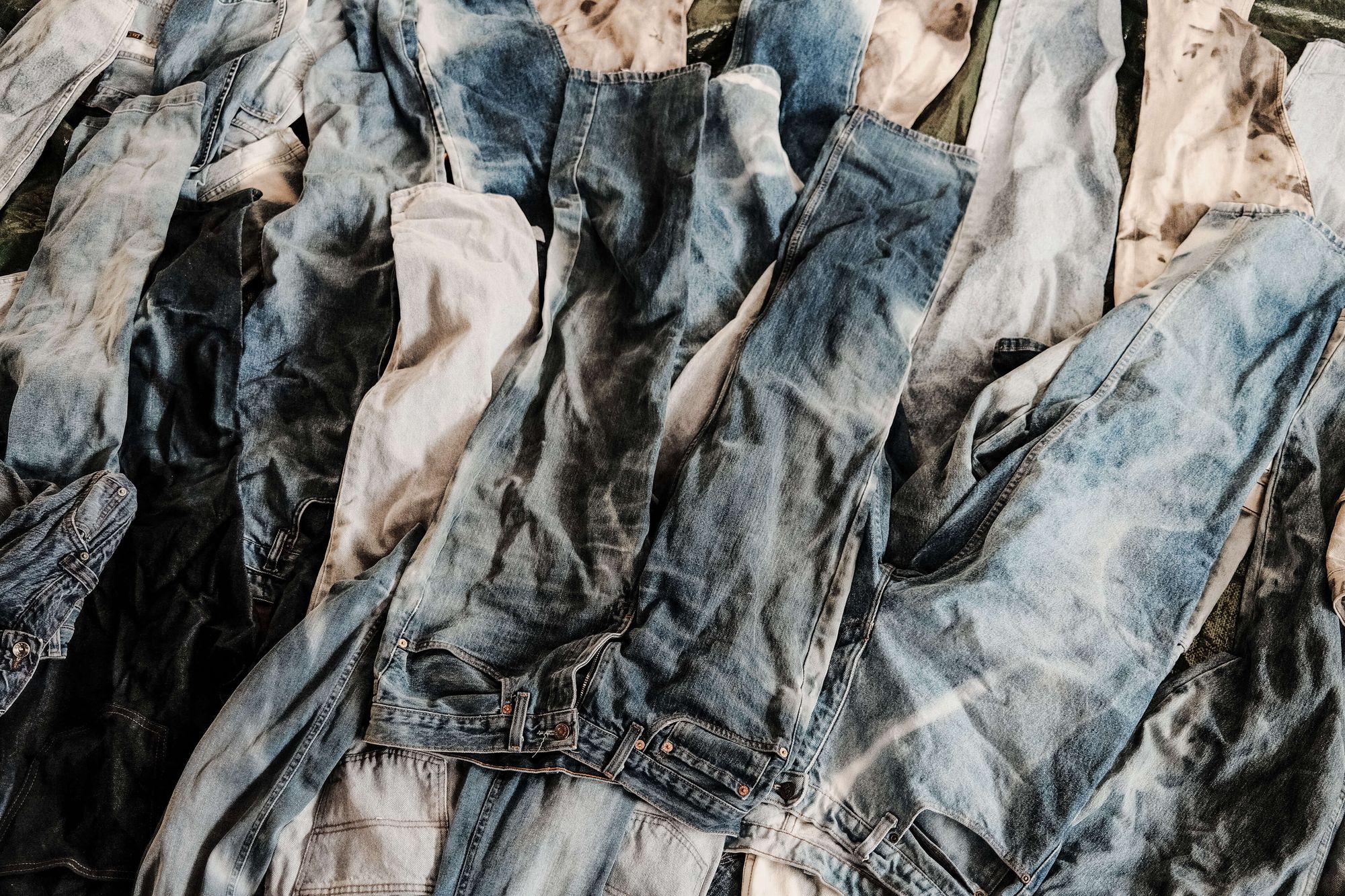 an abstract assortment of jeans laying on the ground