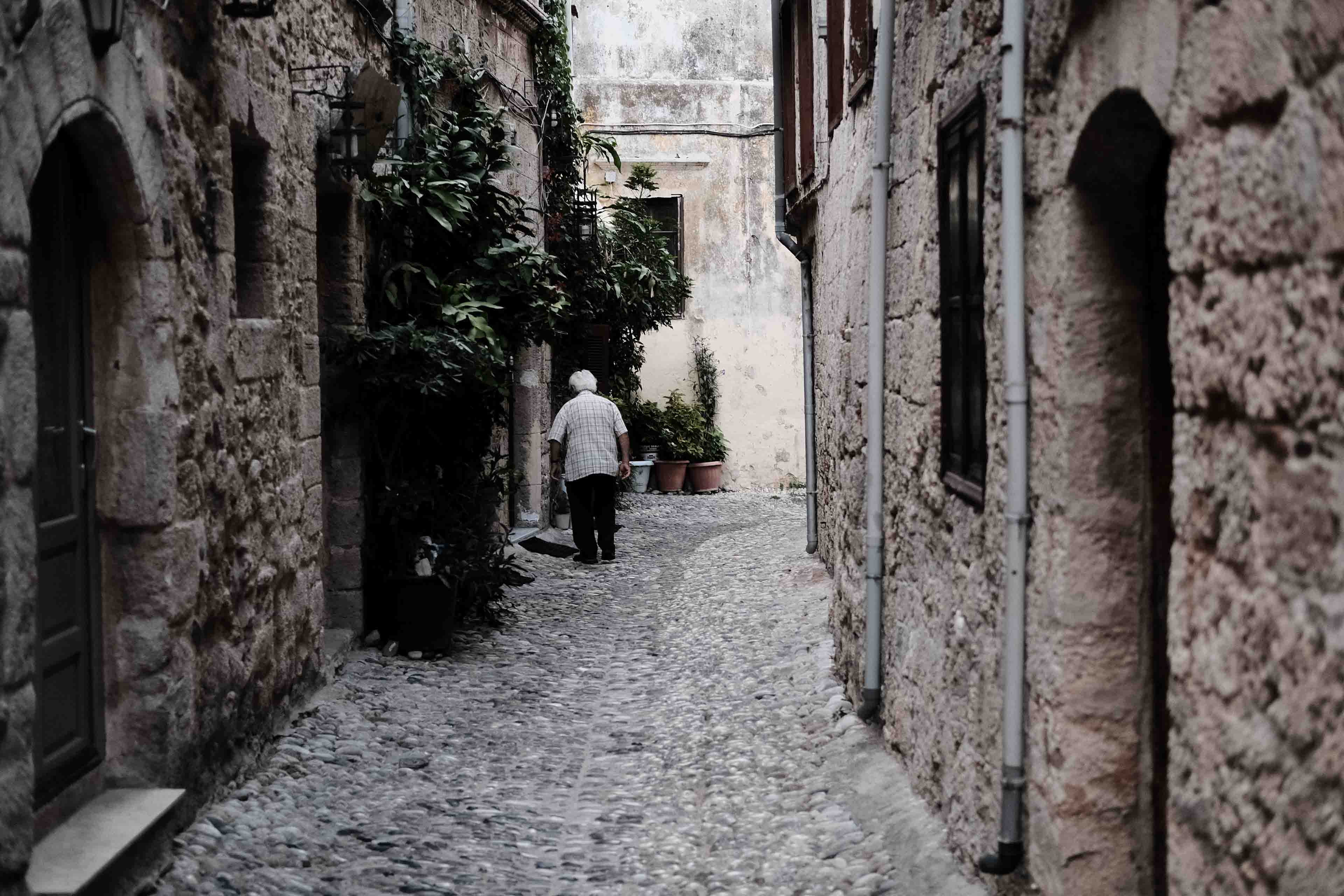 a lady walking through the old streets of Rhodes town