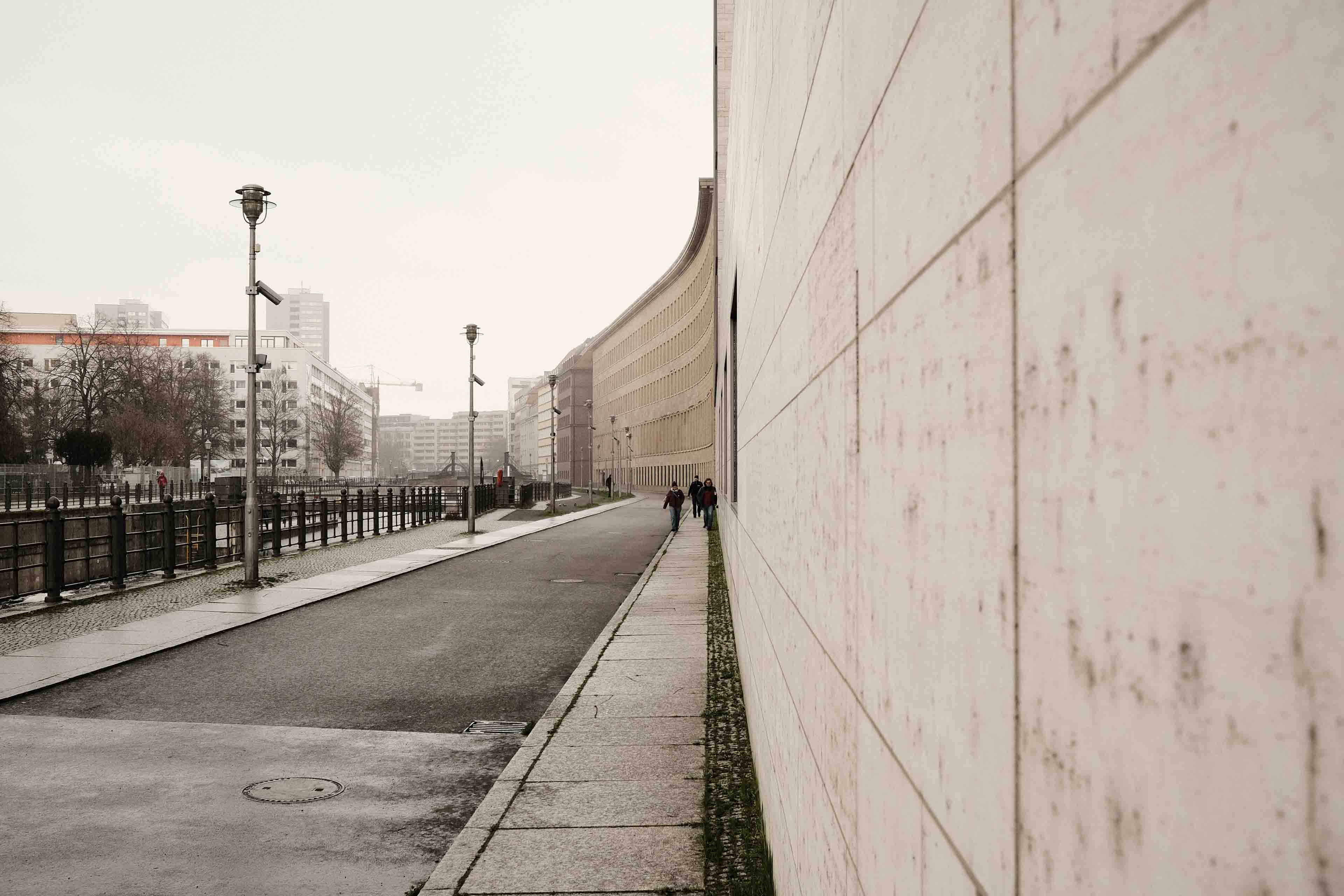 a minimalist wall in Berlin with people in front of it