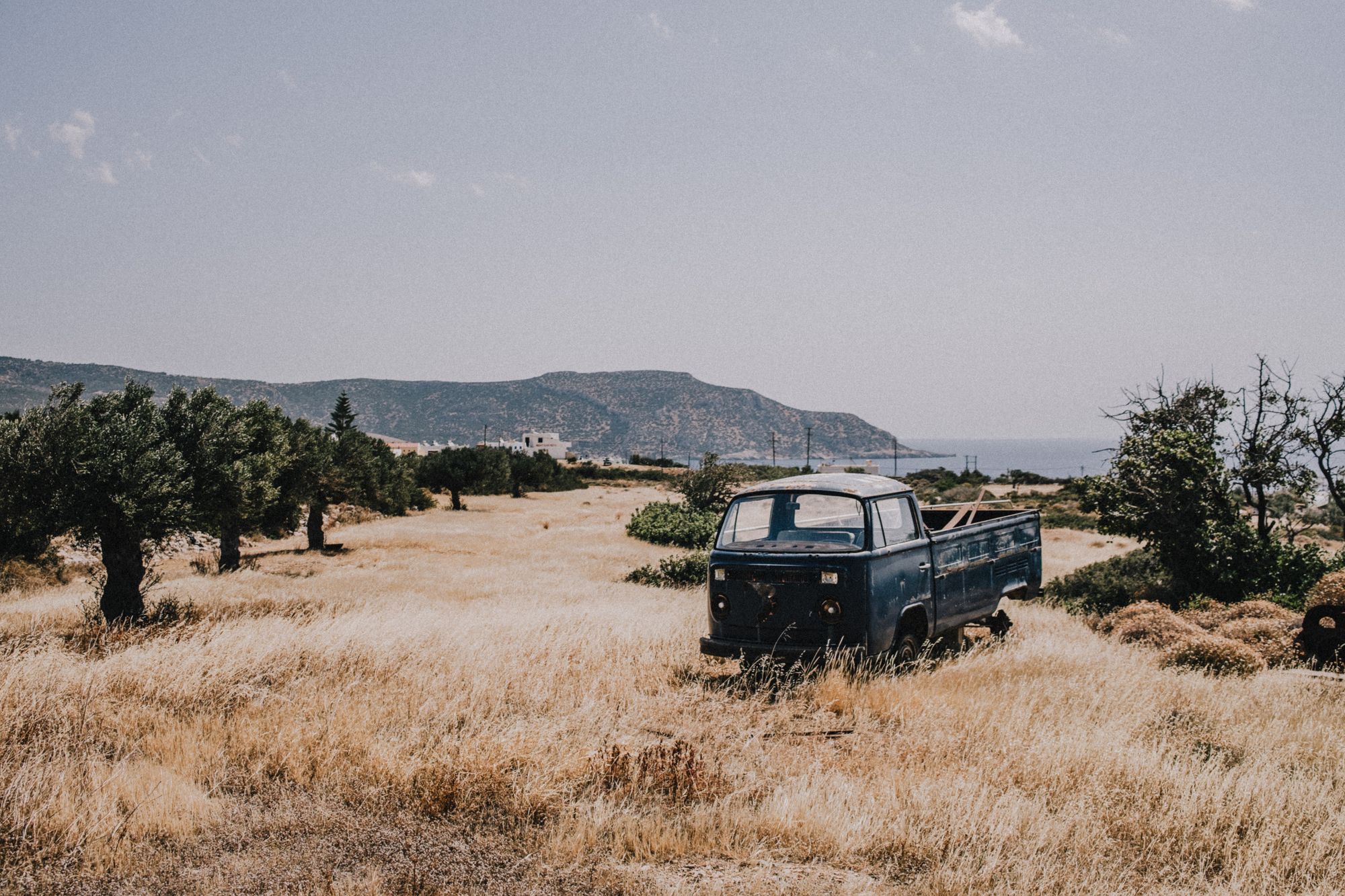 an old abandoned car on a hillside in Karpathos, Greece