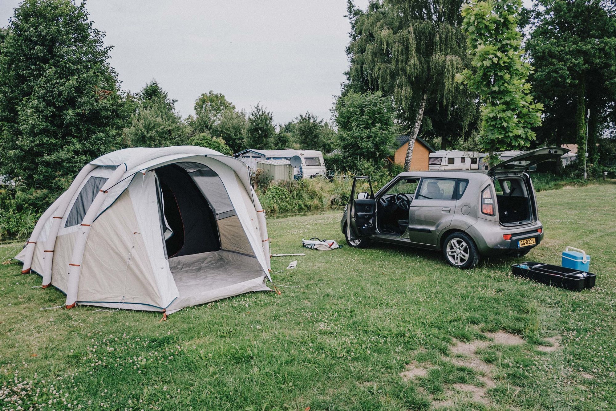 A tent that has just been pitched with a car next to it