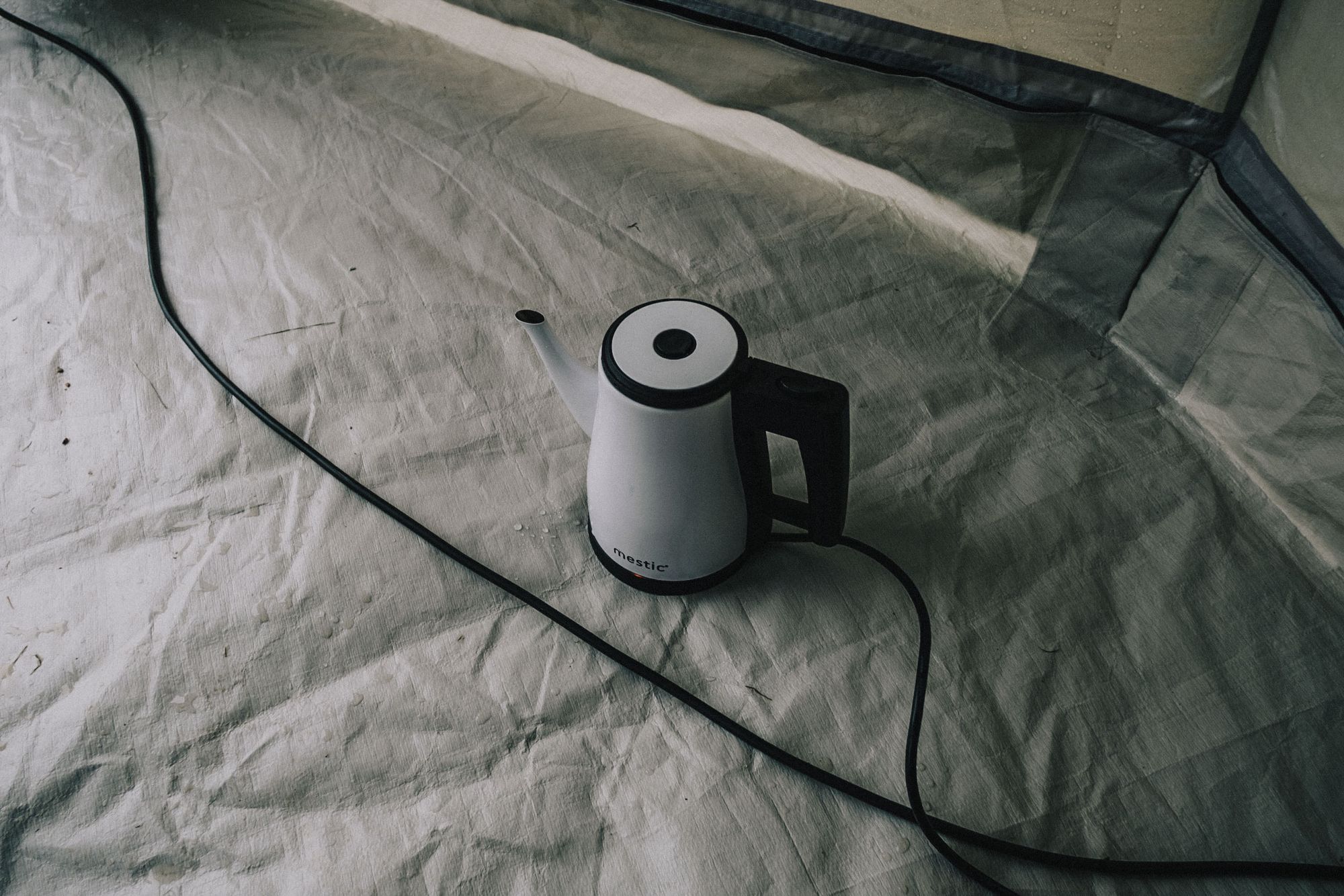 a water kettle on the floor of a tent