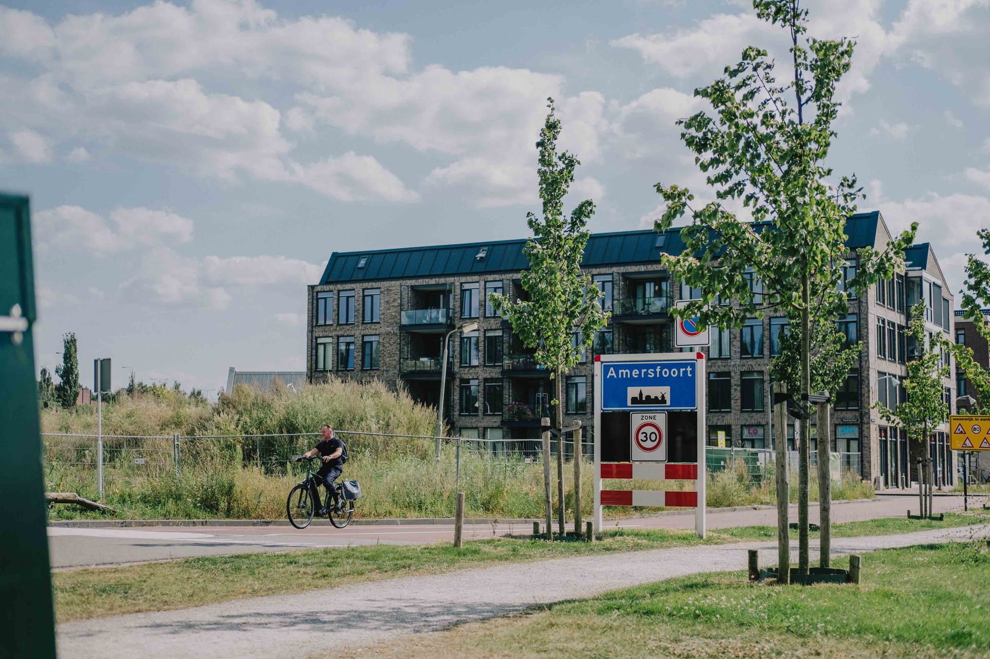 A cyclist passes the Amersfoort municipality sign